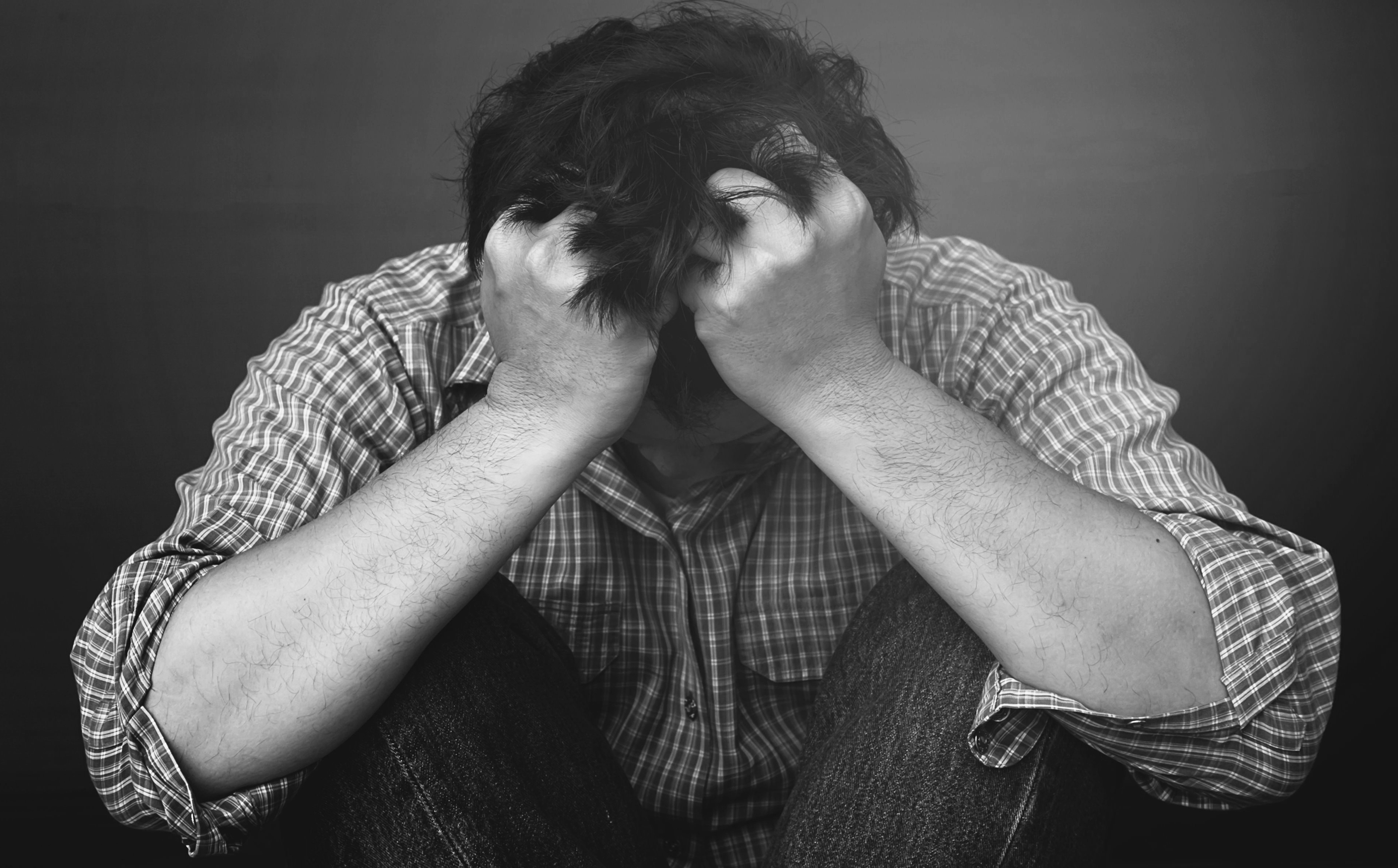 sad-man-holding-head-with-hand.jpg